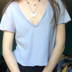 Light blue cropped t-shirt.